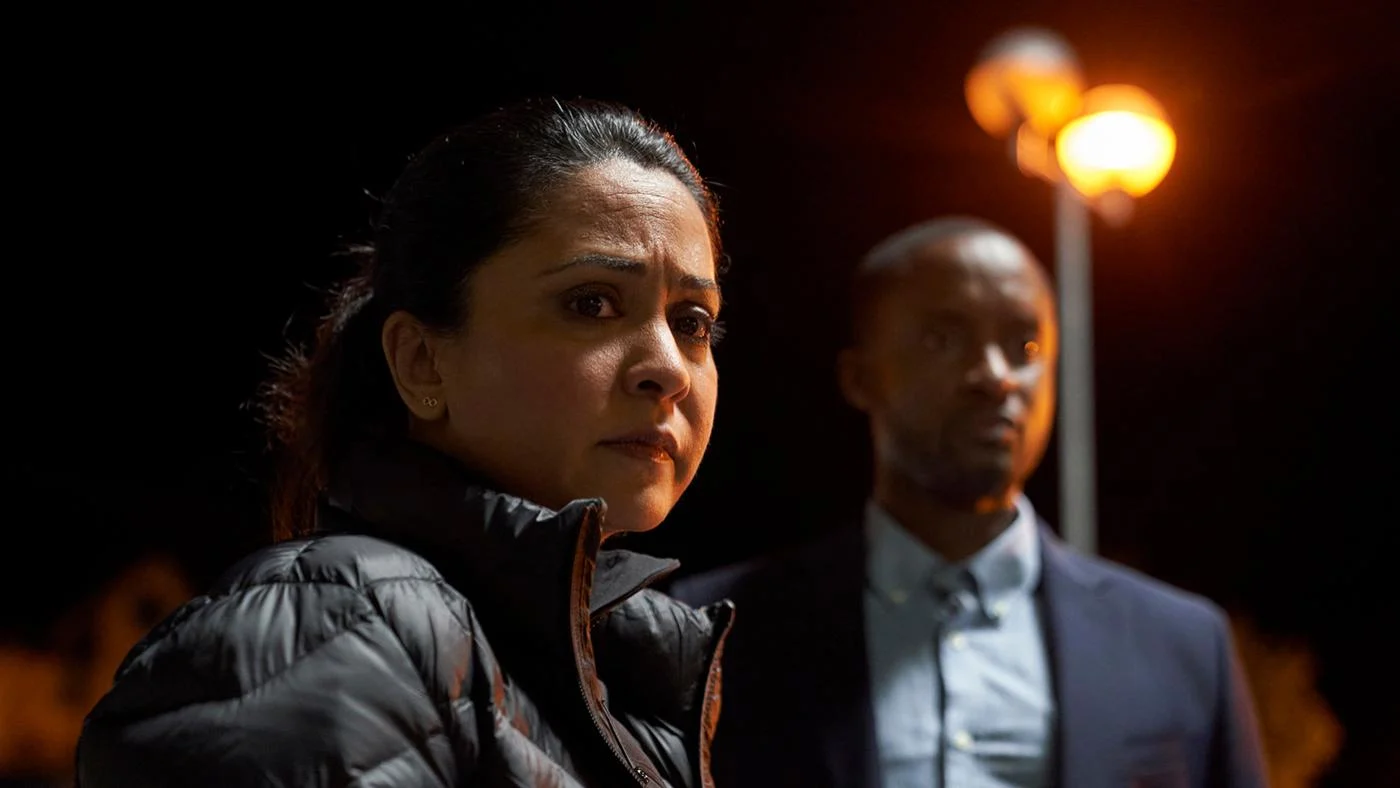 D.I. Ray and Kwesi at nighttime look offscreen