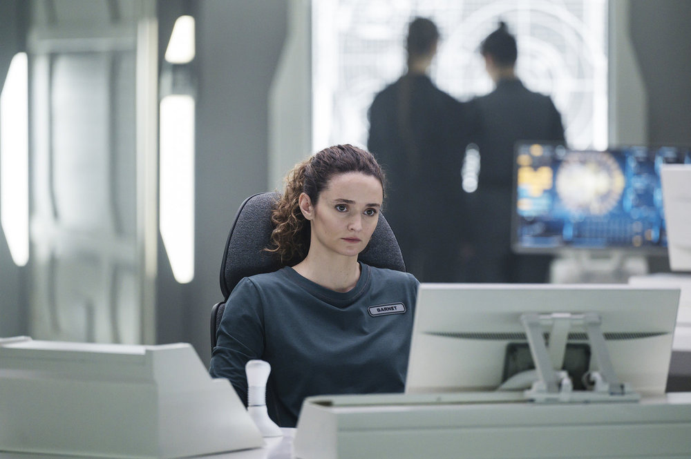 Capt. Garnet sits in her chair on the bridge of a ship in space on The Ark Season 2 Episode 6, "Pretty Big Deal."